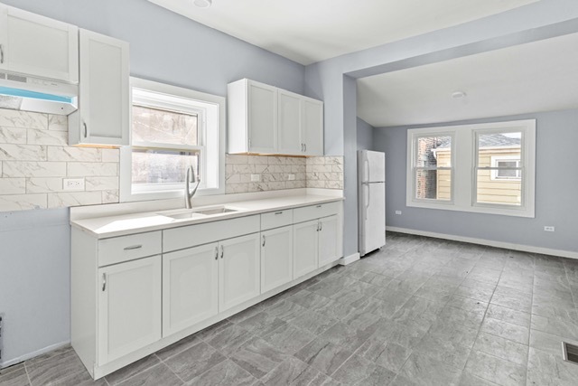 3047 South Broad Street Chicago, IL 60608 - Photo 19 of 25 a spacious bathroom with a granite countertop sink and a window