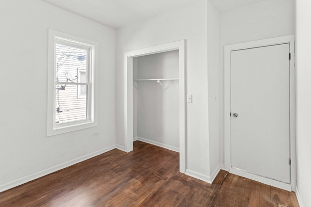 3047 South Broad Street Chicago, IL 60608 - Photo 21 of 25 a view of an empty room with wooden floor and a window