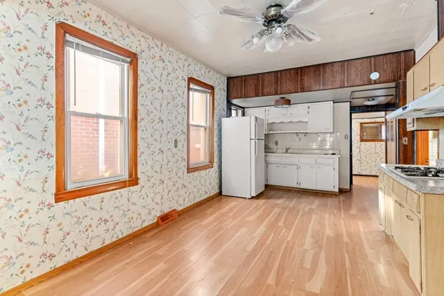 a view of a kitchen with a sink dishwasher and a refrigerator