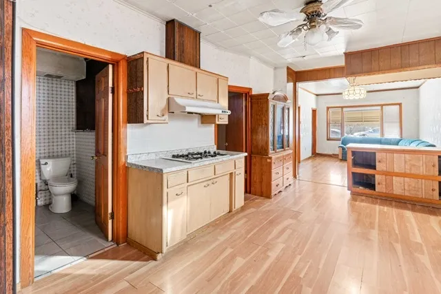 a kitchen with stainless steel appliances a stove refrigerator and cabinets