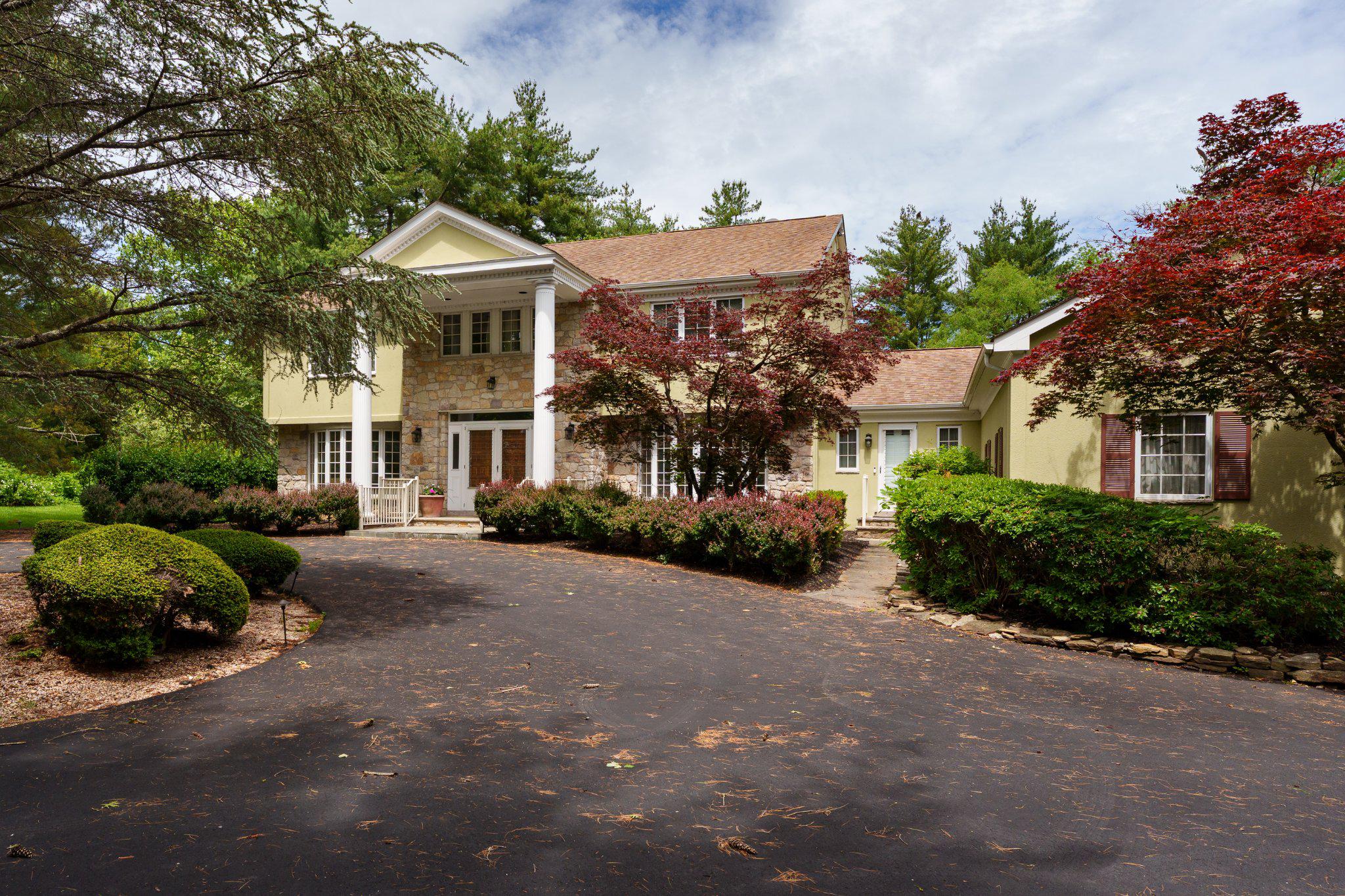 a front view of a house with a garden