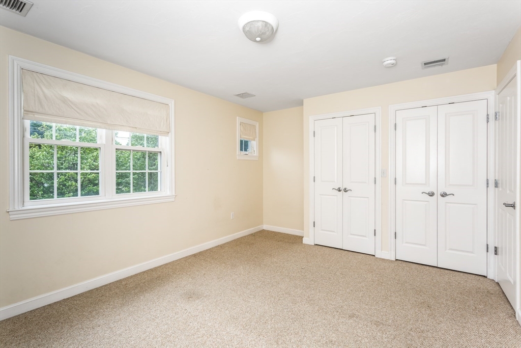 49 Beaver Street, Unit 49 Franklin, MA 02038 - Photo 21 of 46 a view of an empty room with a window