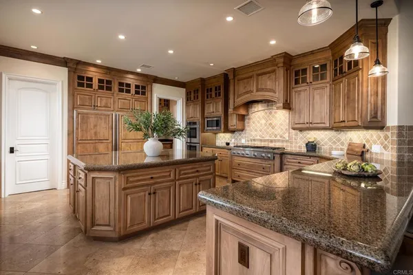 a kitchen with granite countertop a sink and cabinets