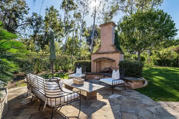 a backyard of a house with table and chairs