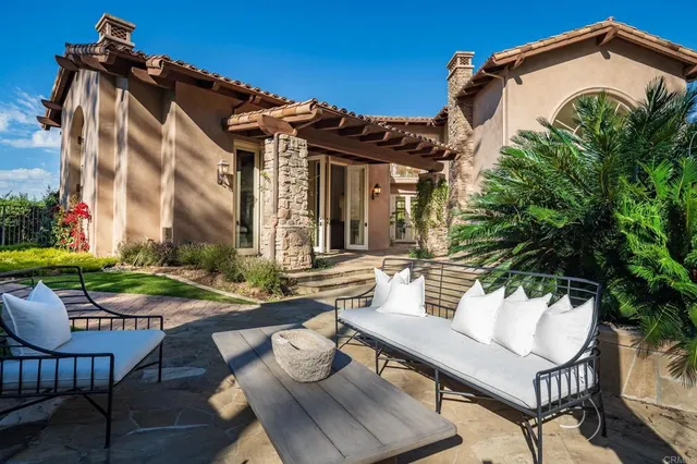 a view of a house with backyard and sitting area