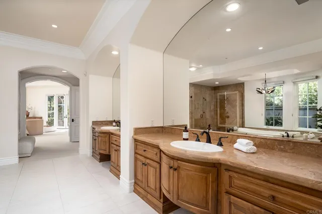 a bathroom with sinks a large mirror and a shower