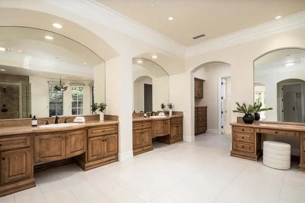 a large bathroom with a large tub and sink