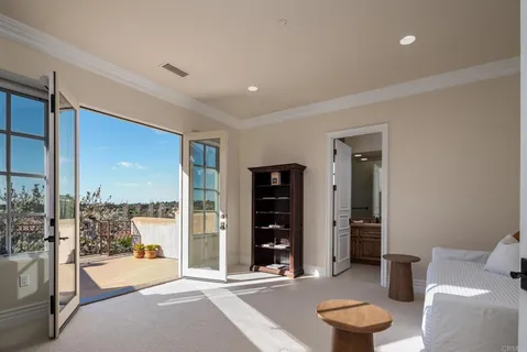 a living room with furniture and a floor to ceiling window