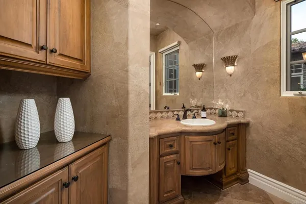 a bathroom with a sink a vanity and window