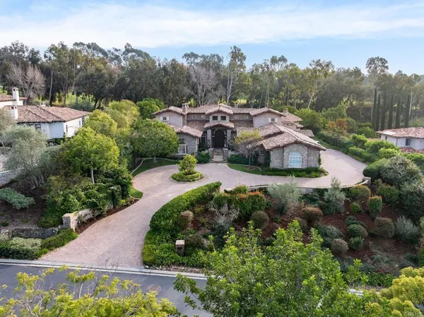 an aerial view of a house with a yard and lake view