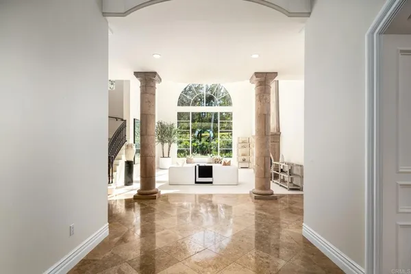a view of a room with a large window and front door