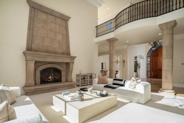 a living room with furniture a fireplace and a table
