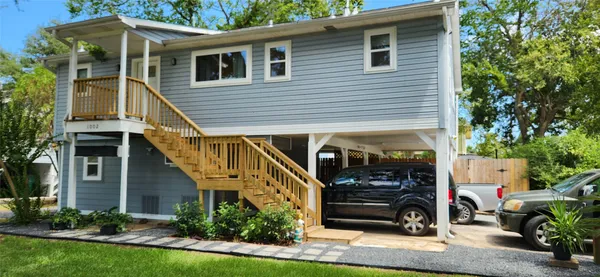 a view of house with outdoor space and car parked