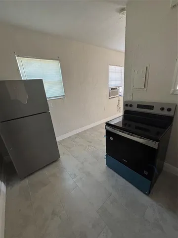 a room with wooden floor and a sink