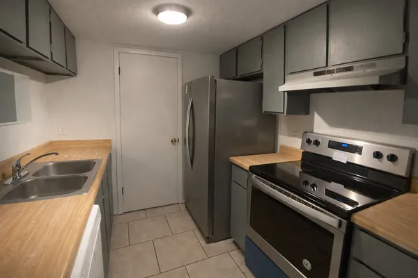 a kitchen with a stove microwave and refrigerator