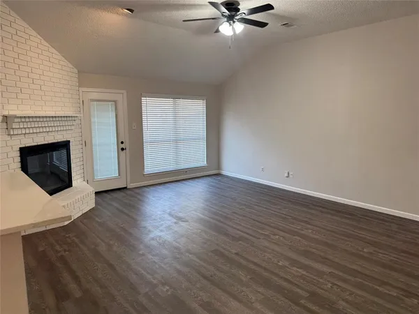 a view of a kitchen with a sink cabinet and a fireplace