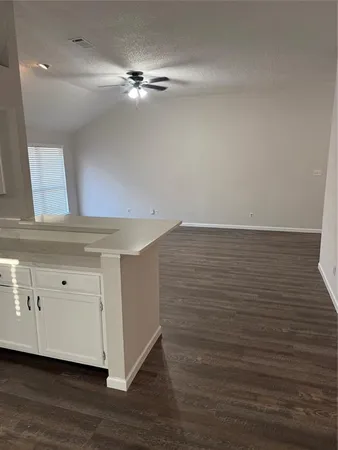 a view of a livingroom with wooden floor and a fireplace