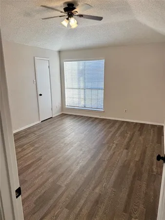 an empty room and a gallery with wooden floor