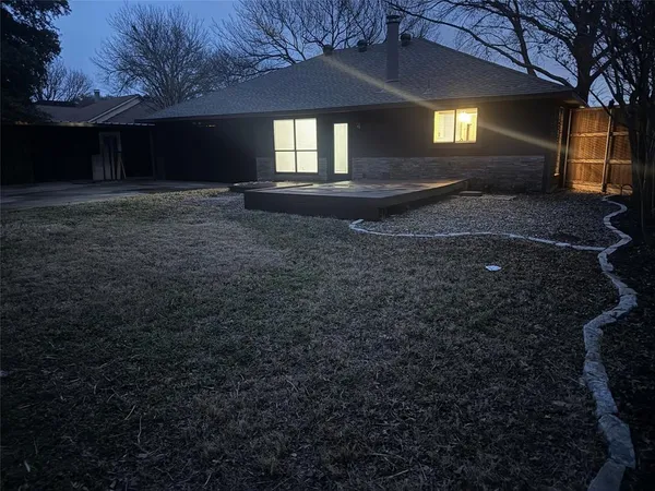 a view of a backyard with wooden fence