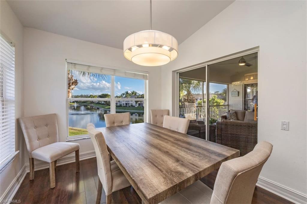 866 Carrick Bend Circle, Unit 201 Naples, FL 34110 - Photo 11 of 35 a view of a dining room with furniture wooden floor and chandelier