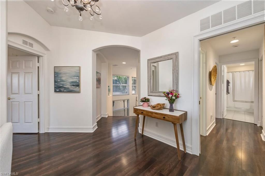 866 Carrick Bend Circle, Unit 201 Naples, FL 34110 - Photo 16 of 35 a living room with furniture and a wooden floor