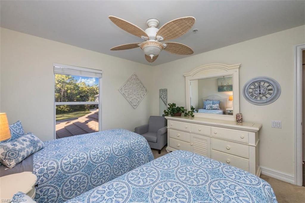 866 Carrick Bend Circle, Unit 201 Naples, FL 34110 - Photo 22 of 35 a living room with furniture and a large window