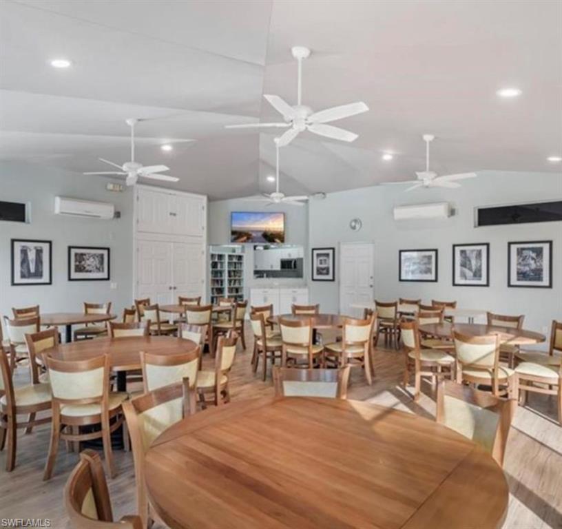 866 Carrick Bend Circle, Unit 201 Naples, FL 34110 - Photo 25 of 35 a living room with lots of furniture and a chandelier