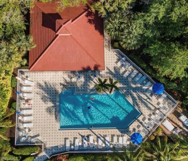 866 Carrick Bend Circle, Unit 201 Naples, FL 34110 - Photo 26 of 35 a view of a wooden house with a yard and a wooden bench
