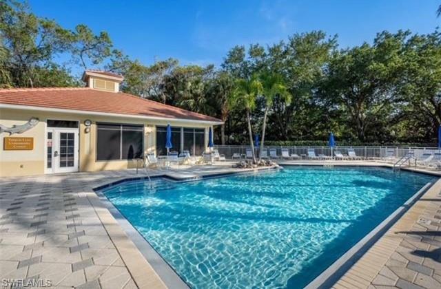 866 Carrick Bend Circle, Unit 201 Naples, FL 34110 - Photo 27 of 35 a view of a house with swimming pool and a yard