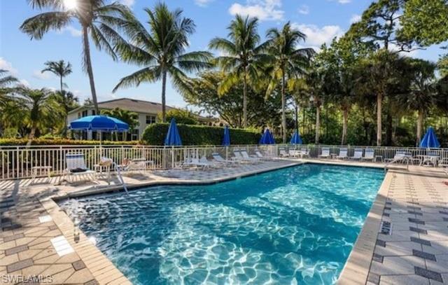 866 Carrick Bend Circle, Unit 201 Naples, FL 34110 - Photo 28 of 35 a view of outdoor space with swimming pool and patio