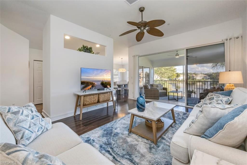 866 Carrick Bend Circle, Unit 201 Naples, FL 34110 - Photo 7 of 35 a living room with furniture and a large window