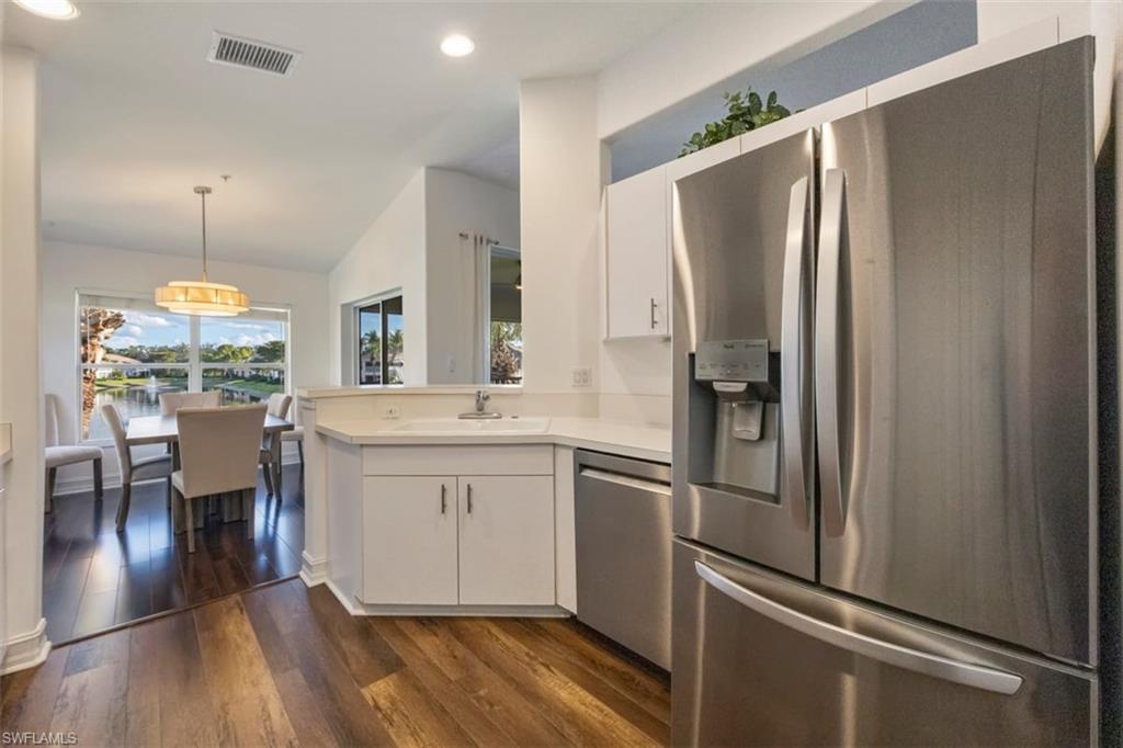 866 Carrick Bend Circle, Unit 201 Naples, FL 34110 - Photo 9 of 35 a kitchen with stainless steel appliances a refrigerator sink and stove