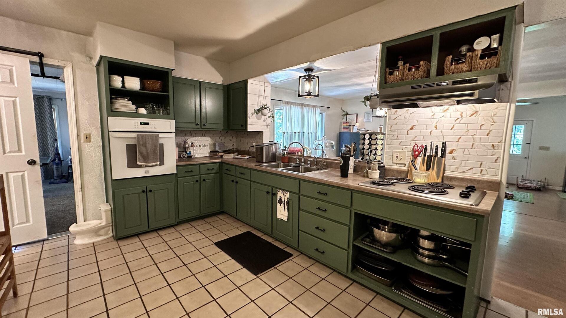 909 North Road West Frankfort, IL 62896 - Photo 14 of 28 a kitchen with a sink a stove and cabinets