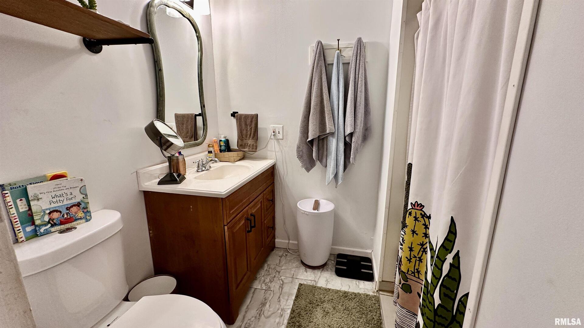 909 North Road West Frankfort, IL 62896 - Photo 24 of 28 a bathroom with a sink a toilet and shower curtain