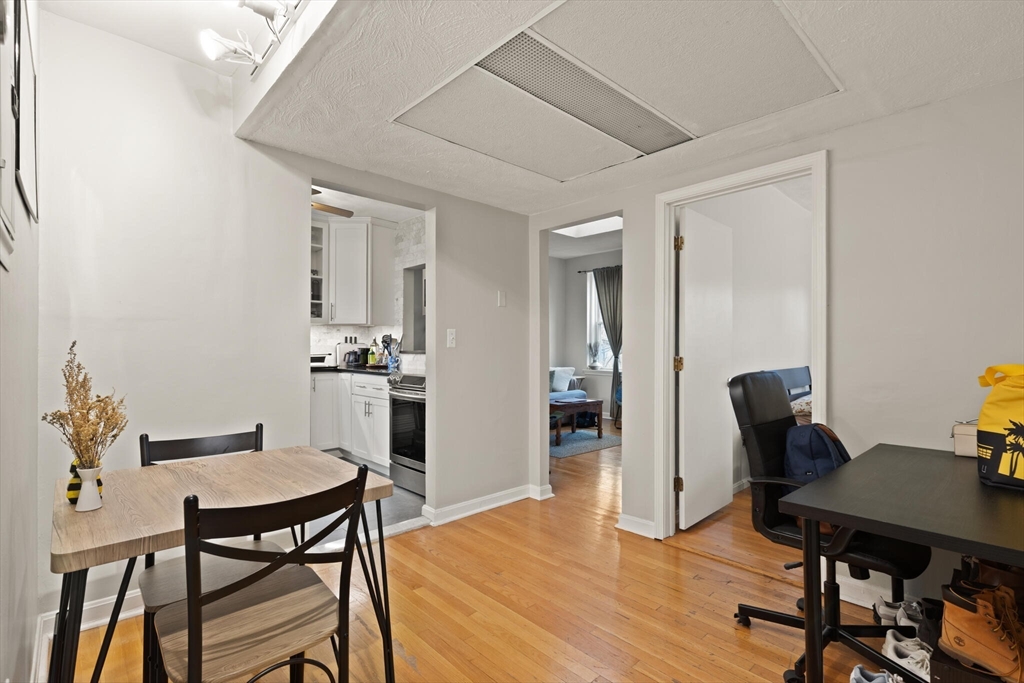 88 Gordon Street, Unit 402 Boston, MA 02135 - Photo 11 of 15 a view of a dining room with furniture and wooden floor