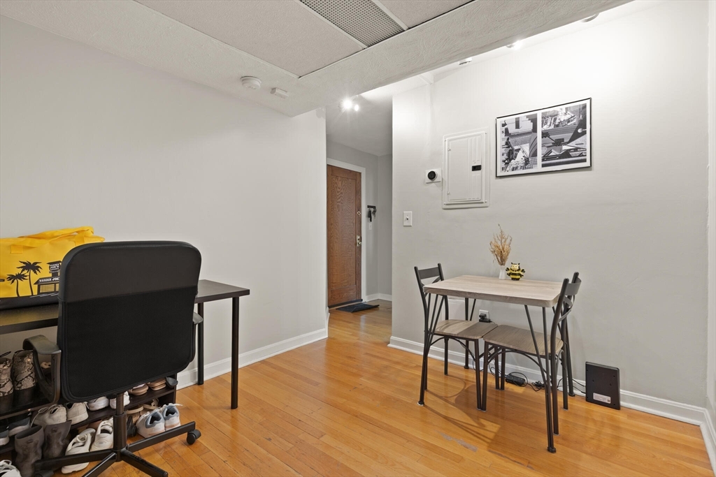 88 Gordon Street, Unit 402 Boston, MA 02135 - Photo 12 of 15 a view of a workspace with furniture and wooden floor