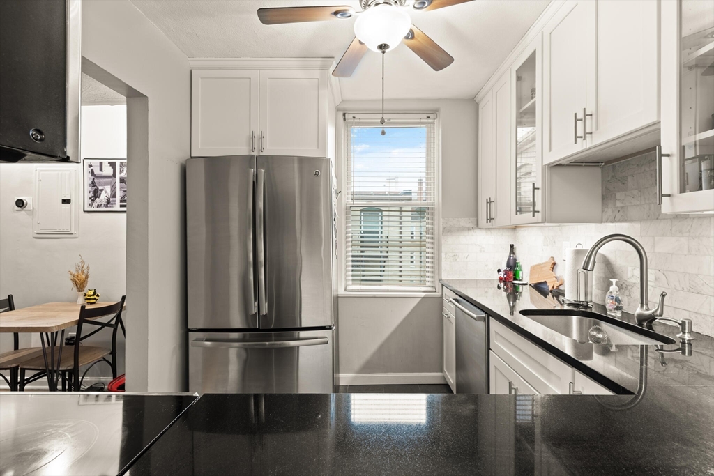 88 Gordon Street, Unit 402 Boston, MA 02135 - Photo 2 of 15 a kitchen with stainless steel appliances a refrigerator sink and cabinets