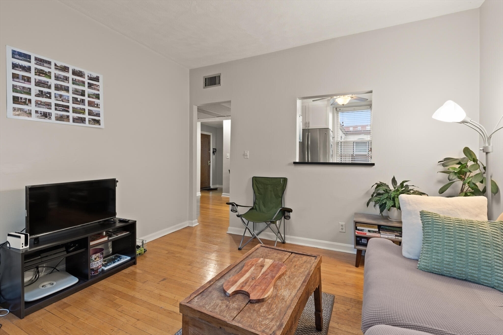 88 Gordon Street, Unit 402 Boston, MA 02135 - Photo 5 of 15 a living room with furniture a flat screen tv and a window
