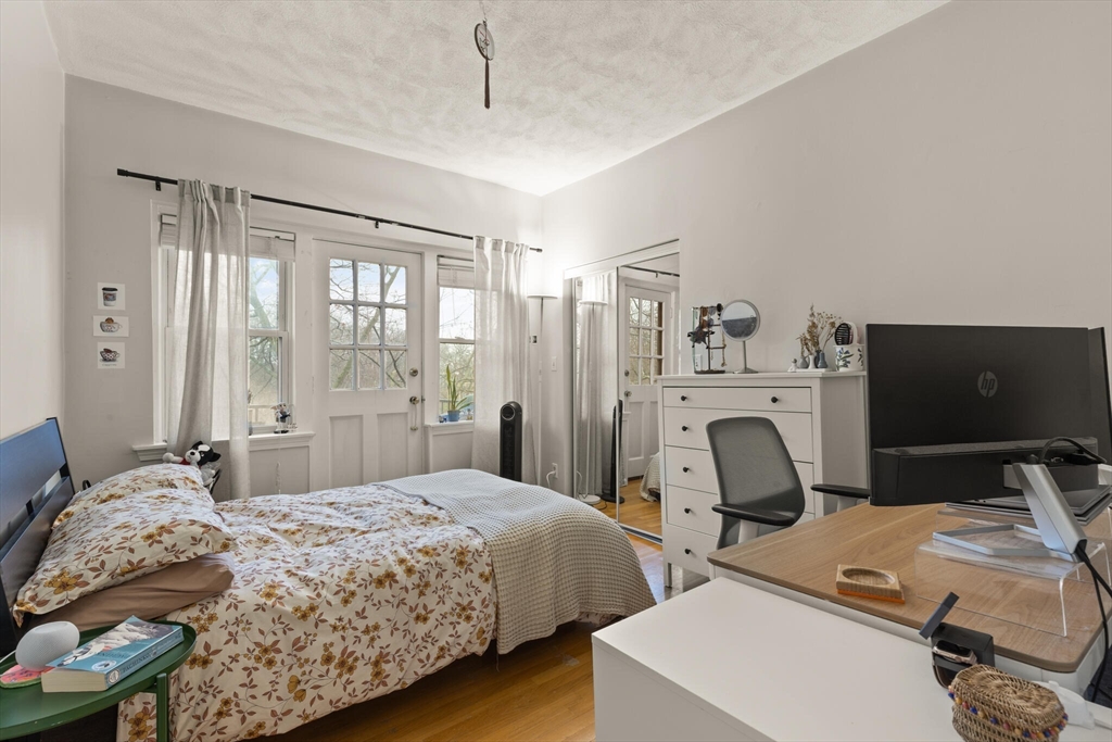 88 Gordon Street, Unit 402 Boston, MA 02135 - Photo 6 of 15 a bedroom with a bed and a flat screen tv