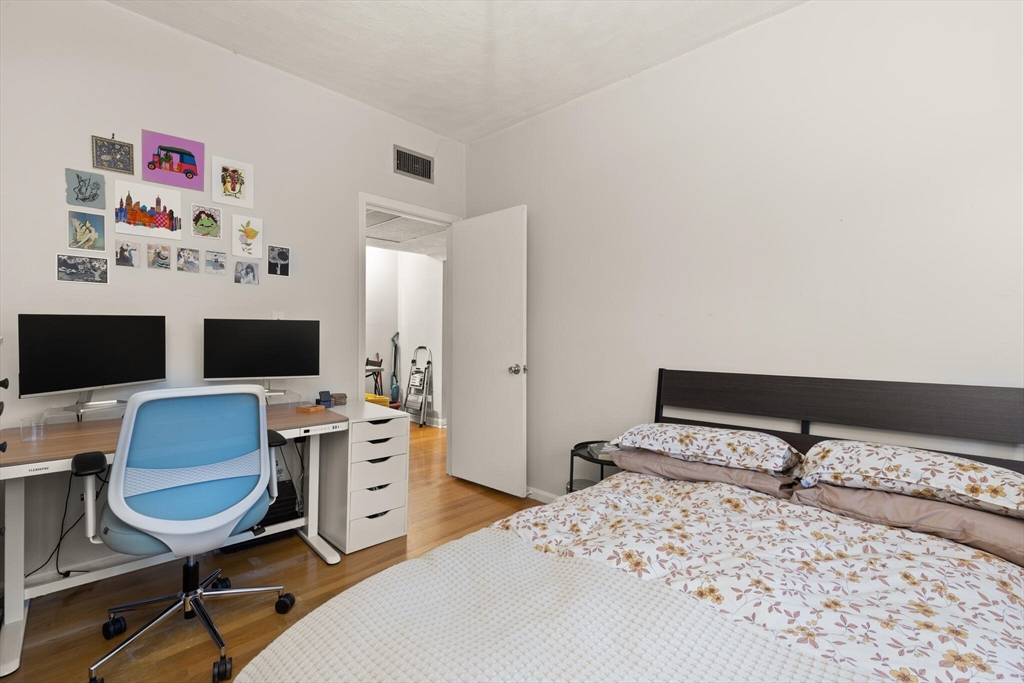 88 Gordon Street, Unit 402 Boston, MA 02135 - Photo 9 of 15 a bedroom with a bed and a desk