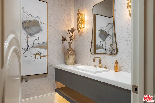 a bathroom with a sink and mirror