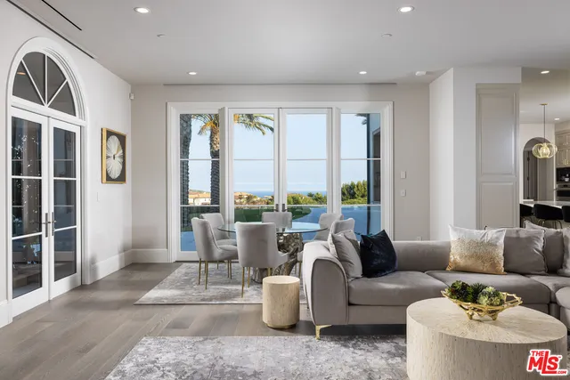 a living room with furniture and large windows