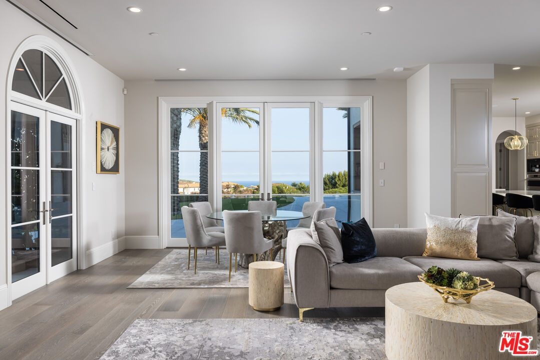 28 Tide Watch Newport Coast, CA 92657 - Photo 15 of 23 a living room with furniture and large windows