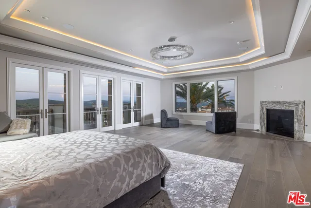 a large bedroom with a large bed and a large window