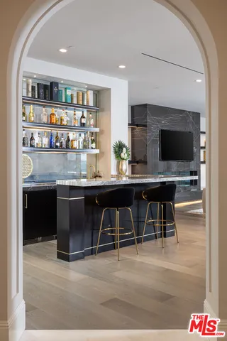 a room with stainless steel appliances kitchen island granite countertop a stove and cabinets