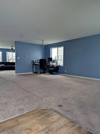 a view of a livingroom with furniture and a window