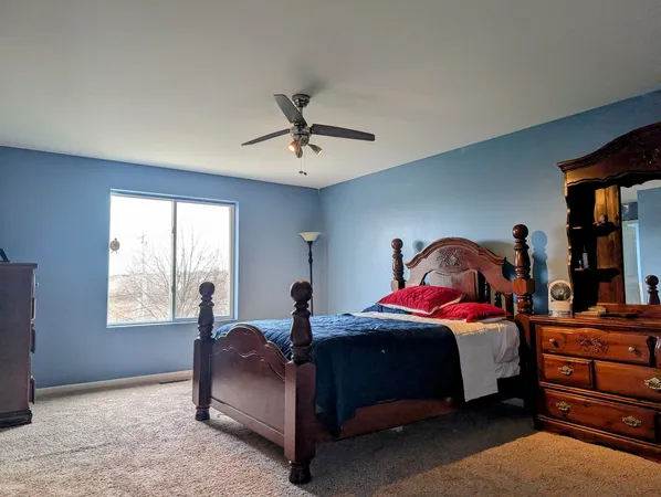 a bed room with a bed and a window