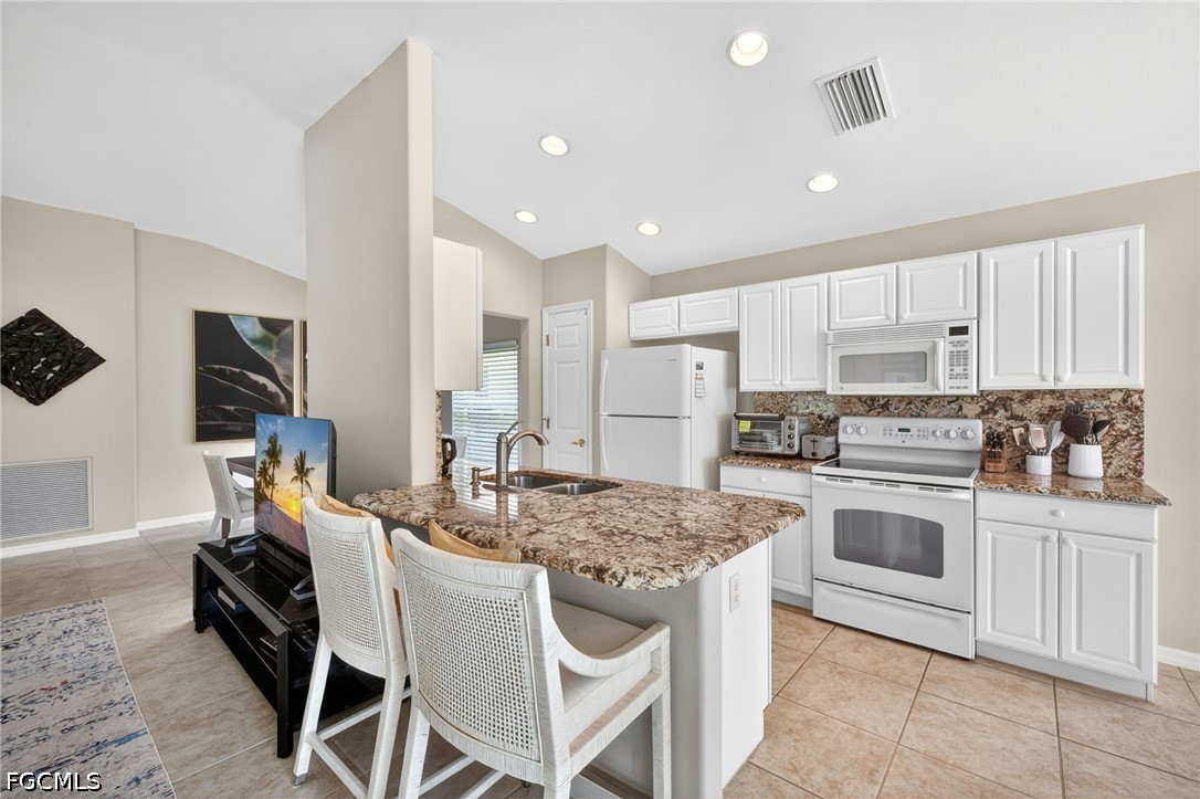10082 Oakhurst Way Fort Myers, FL 33913 - Photo 11 of 50 a kitchen with stainless steel appliances granite countertop a stove refrigerator sink and cabinets