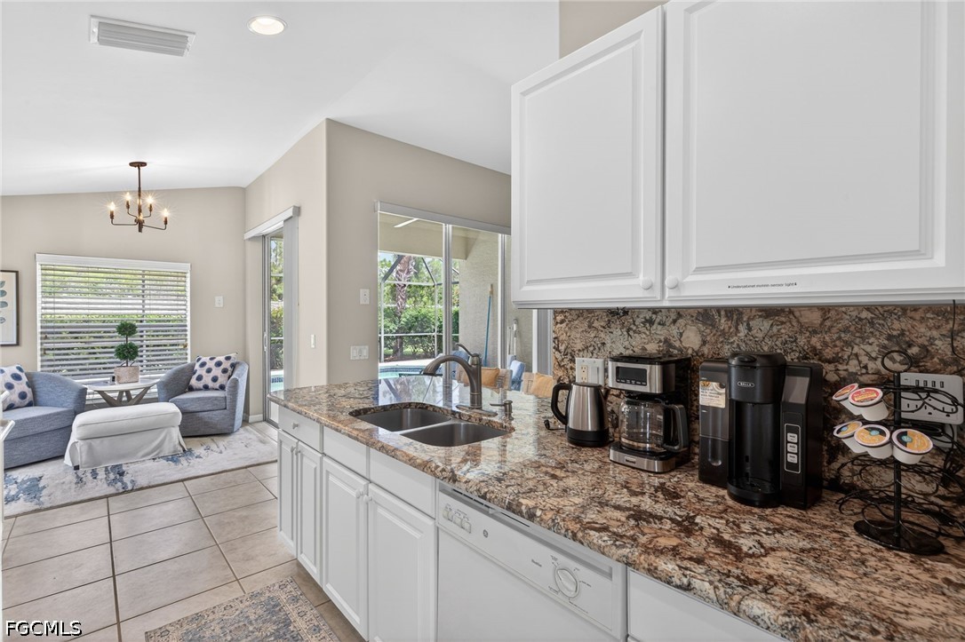 10082 Oakhurst Way Fort Myers, FL 33913 - Photo 14 of 50 a kitchen with stainless steel appliances granite countertop a sink and a white cabinets