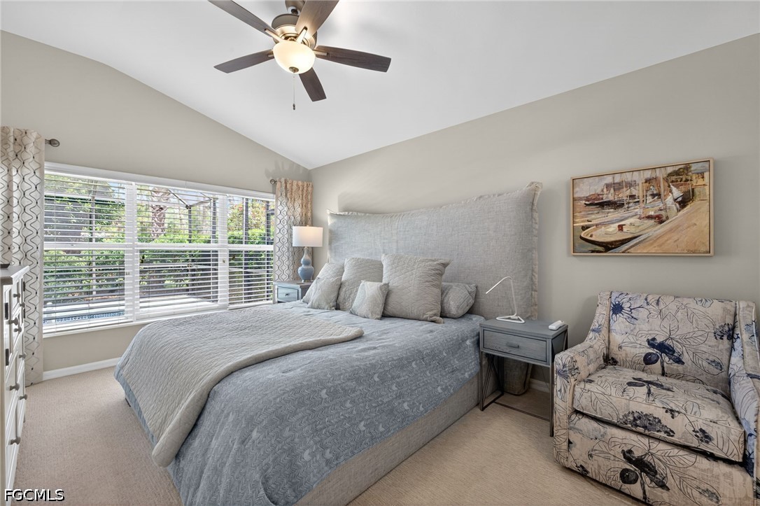 10082 Oakhurst Way Fort Myers, FL 33913 - Photo 18 of 50 a bedroom with a large bed and a large window